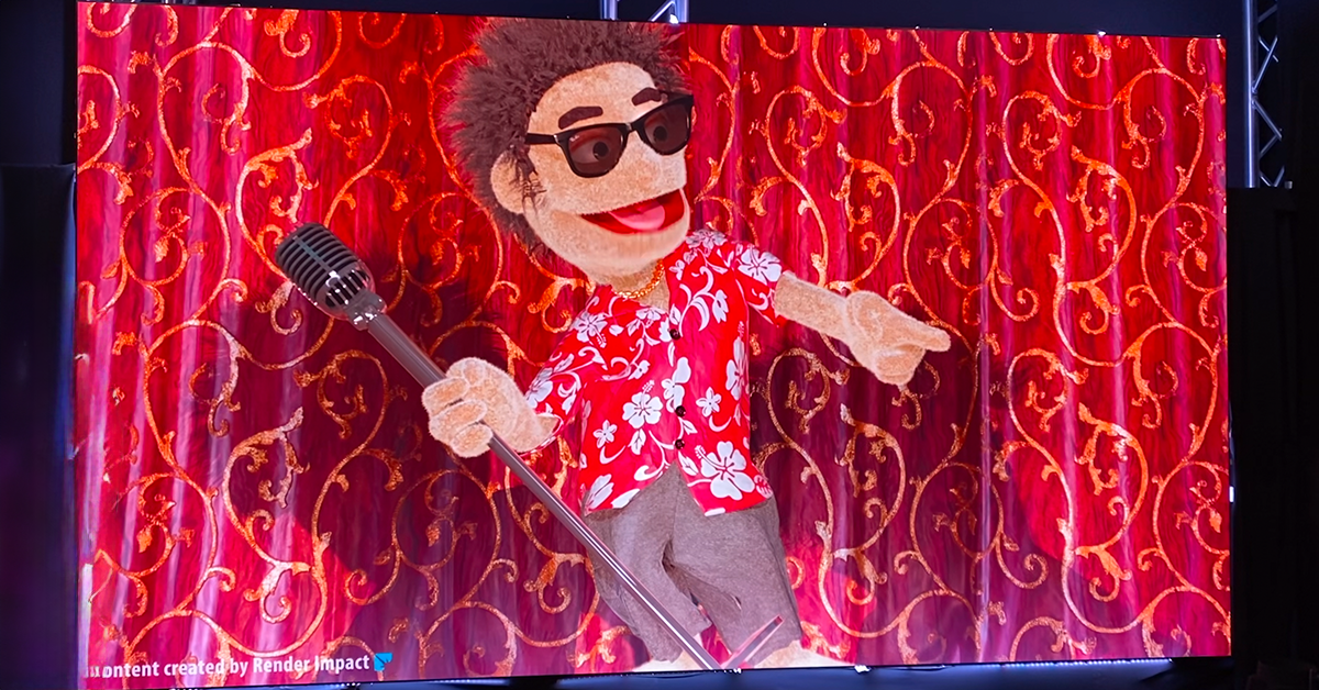 3D animated puppet on stage holding a microphone